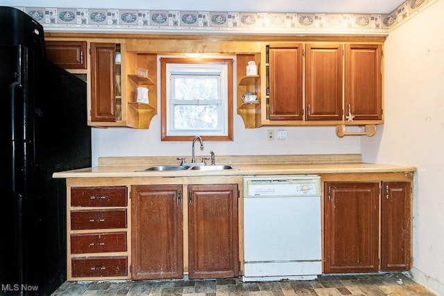 kitchen with dishwasher, freestanding refrigerator, light countertops, open shelves, and a sink