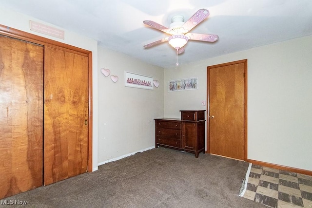 unfurnished bedroom featuring a ceiling fan, carpet flooring, and baseboards