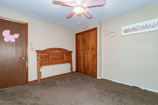 unfurnished bedroom featuring carpet, a ceiling fan, and baseboards