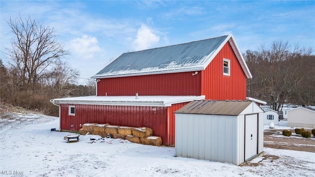 snow covered structure with an outdoor structure