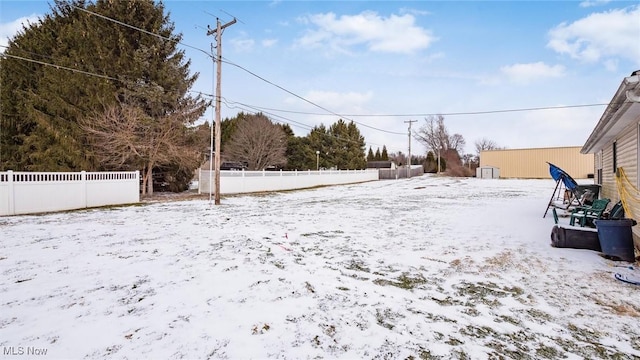 snowy yard with fence