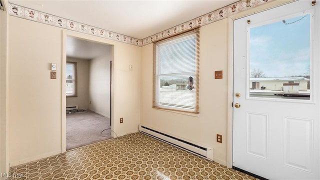 doorway featuring a baseboard radiator and baseboards