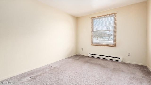 empty room with carpet, a baseboard heating unit, and baseboards