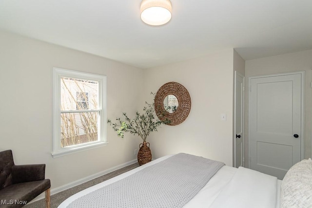 bedroom with carpet floors and baseboards