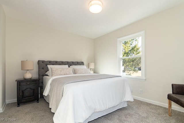 bedroom featuring carpet floors and baseboards