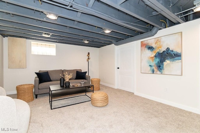 carpeted living room featuring baseboards