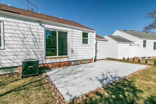 rear view of house with a yard, a patio, and central air condition unit