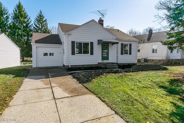 view of front of house featuring cooling unit, a garage, a shingled roof, concrete driveway, and a front yard