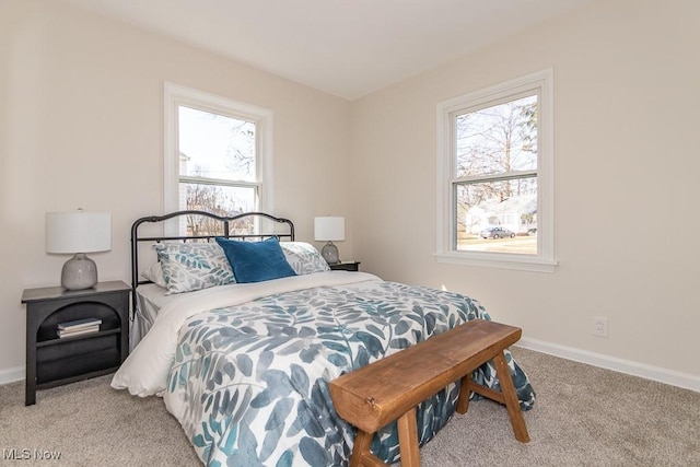 bedroom with carpet floors and baseboards