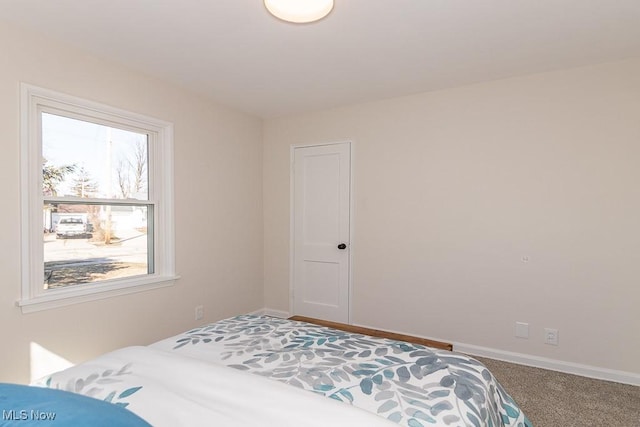 carpeted bedroom with baseboards