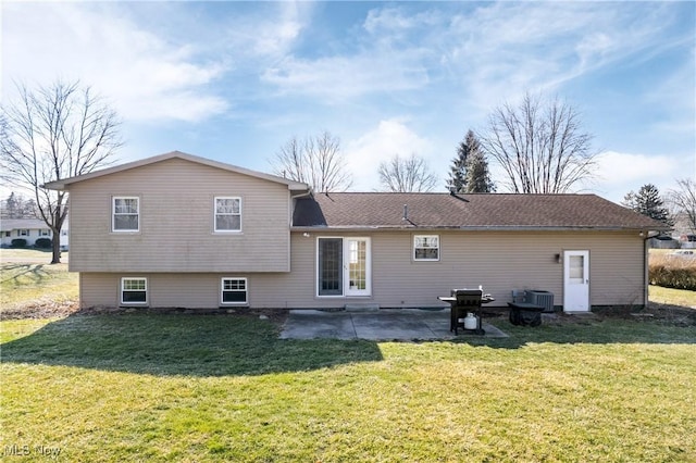 back of house featuring central air condition unit, a patio area, and a lawn