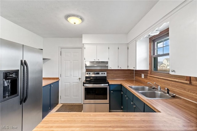 kitchen featuring stainless steel appliances, light countertops, a sink, and under cabinet range hood