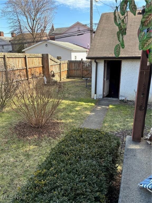 view of yard featuring an outbuilding and a fenced backyard