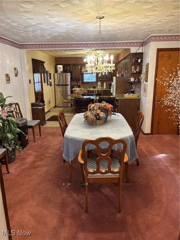 dining space with light carpet and a notable chandelier