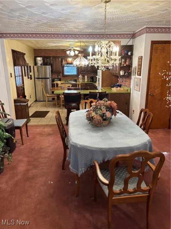 dining space with light carpet and light tile patterned floors