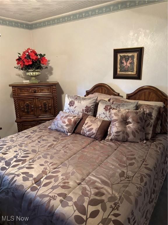 bedroom with ornamental molding