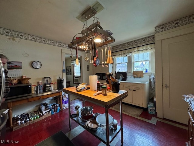 kitchen with stainless steel microwave and tile patterned floors