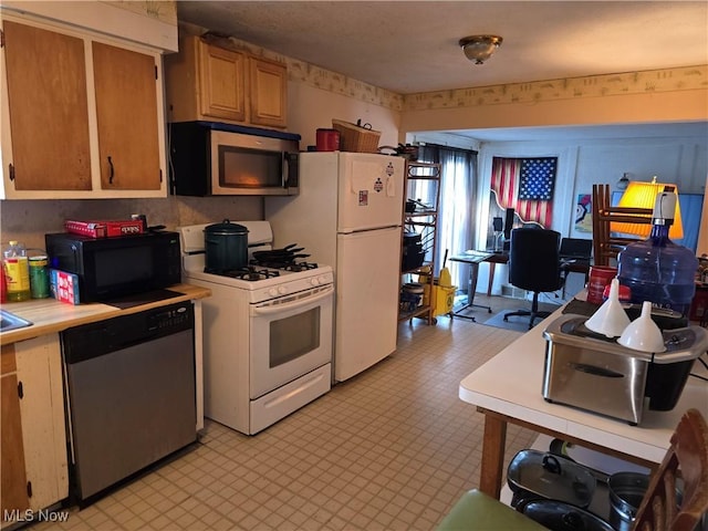 kitchen with stainless steel appliances, light countertops, and light floors