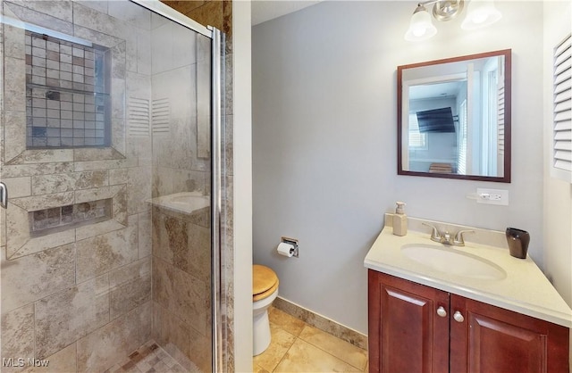 full bath with tile patterned flooring, toilet, vanity, baseboards, and a shower stall