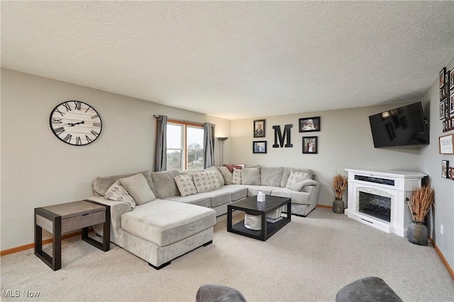 carpeted living room featuring a textured ceiling, a fireplace, and baseboards