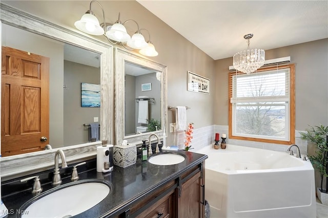 bathroom with a whirlpool tub, double vanity, a sink, and a notable chandelier