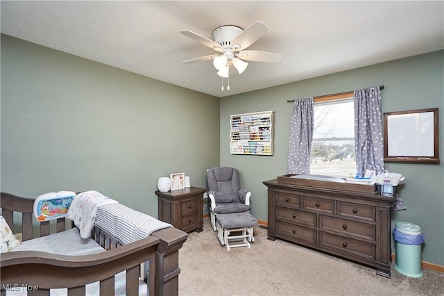 bedroom with light carpet, ceiling fan, and baseboards