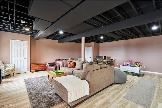 living room with baseboards and wood finished floors