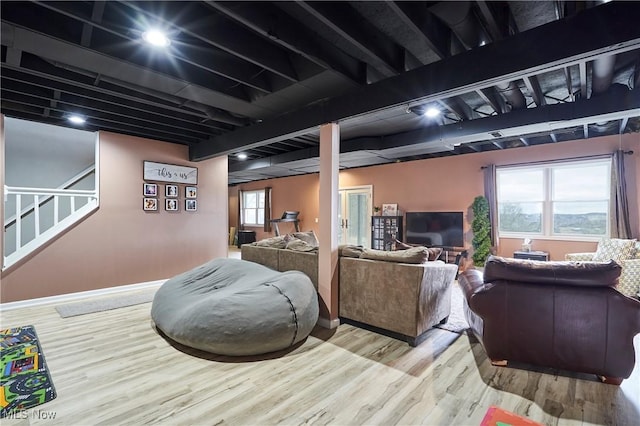 interior space with stairway, wood finished floors, and baseboards