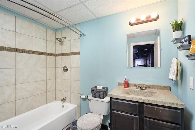 full bath with a paneled ceiling, shower / bath combination, vanity, and toilet