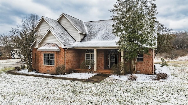 traditional home featuring crawl space, brick siding, covered porch, and roof with shingles