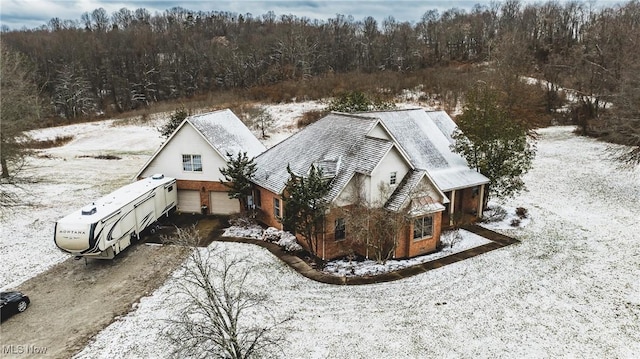 snowy aerial view with a view of trees