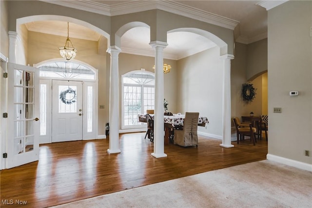 1003 Duncan Ln, Parkersburg, WV 26104 - entryway with arched walkways, a chandelier, baseboards, wood finished floors, and ornate columns