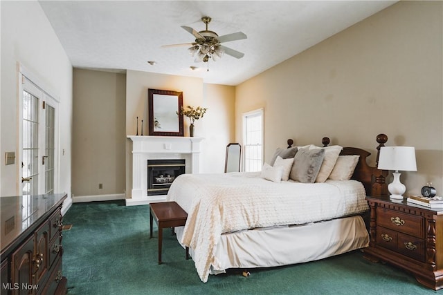 1003 Duncan Ln, Parkersburg, WV 26104 - bedroom featuring a ceiling fan, baseboards, a glass covered fireplace, and dark carpet