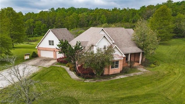 1003 Duncan Ln, Parkersburg, WV 26104 - exterior space featuring a view of trees, concrete driveway, a front lawn, and brick siding