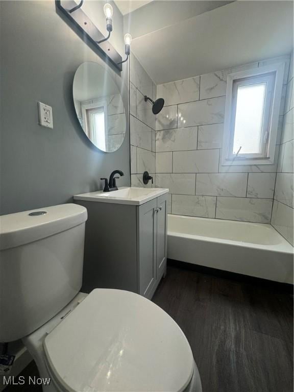 full bath with shower / bathing tub combination, vanity, toilet, and wood finished floors