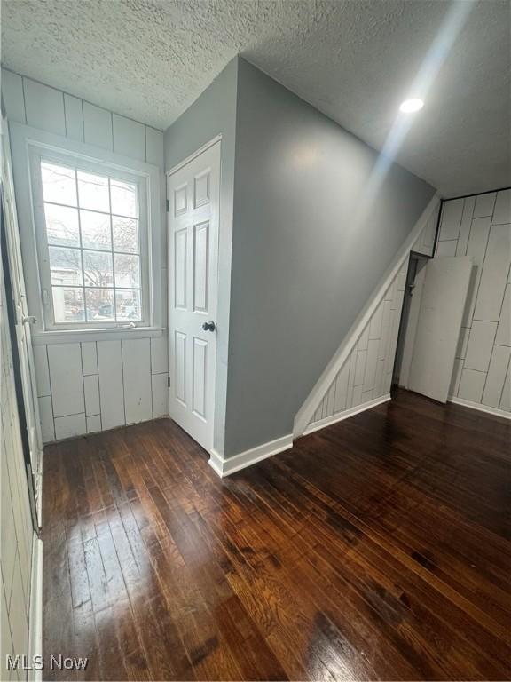 empty room featuring hardwood / wood-style flooring and a textured ceiling