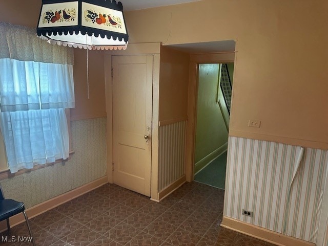 13705 Graham Ave, Cleveland, OH 44112 - unfurnished room featuring baseboards and wallpapered walls