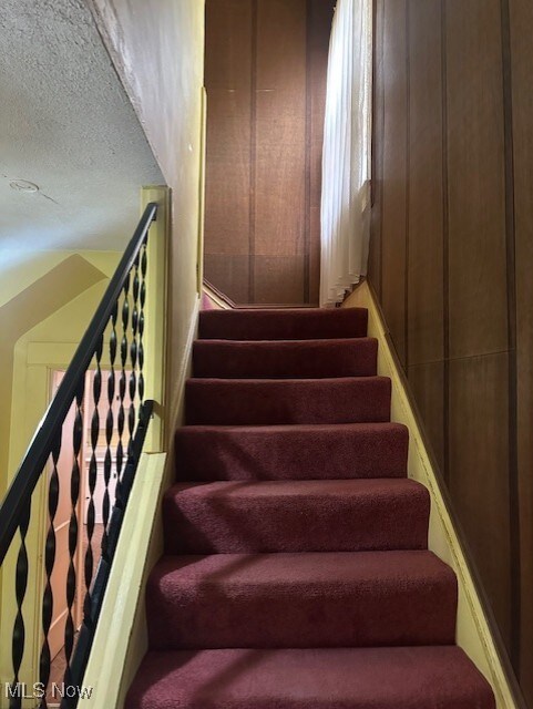 13705 Graham Ave, Cleveland, OH 44112 - stairway featuring a textured ceiling