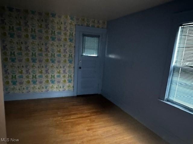 13705 Graham Ave, Cleveland, OH 44112 - spare room with baseboards and wood finished floors