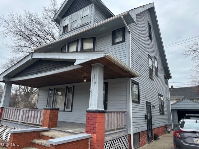 13705 Graham Ave, Cleveland, OH 44112 - view of front of house featuring an outbuilding and covered porch