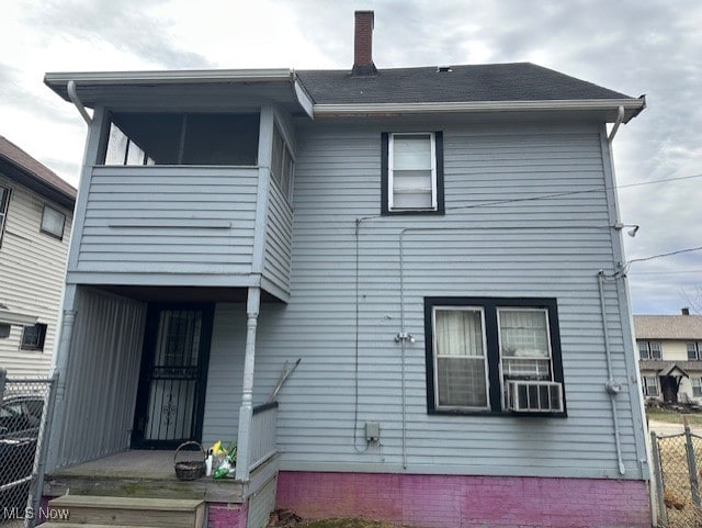 13705 Graham Ave, Cleveland, OH 44112 - rear view of house with a chimney and fence