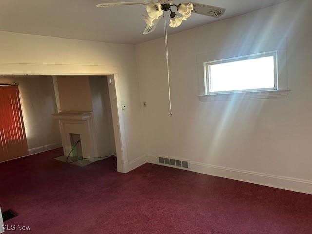 13705 Graham Ave, Cleveland, OH 44112 - empty room featuring ceiling fan, baseboards, visible vents, and dark carpet