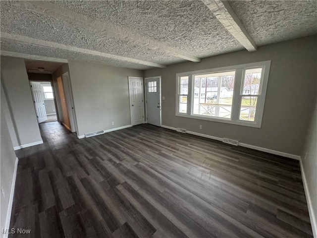 interior space featuring baseboards, visible vents, and dark wood-style flooring