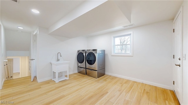 laundry area featuring baseboards, visible vents, washing machine and clothes dryer, light wood-style floors, and recessed lighting