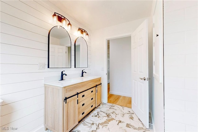 bathroom featuring a sink and double vanity