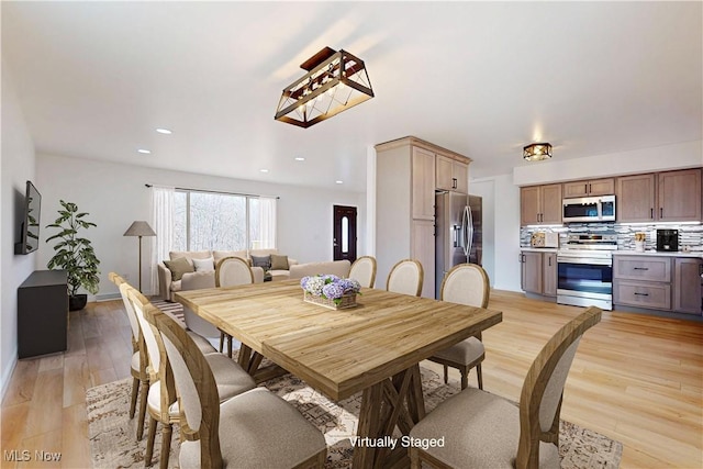 dining space with light wood-style floors and recessed lighting