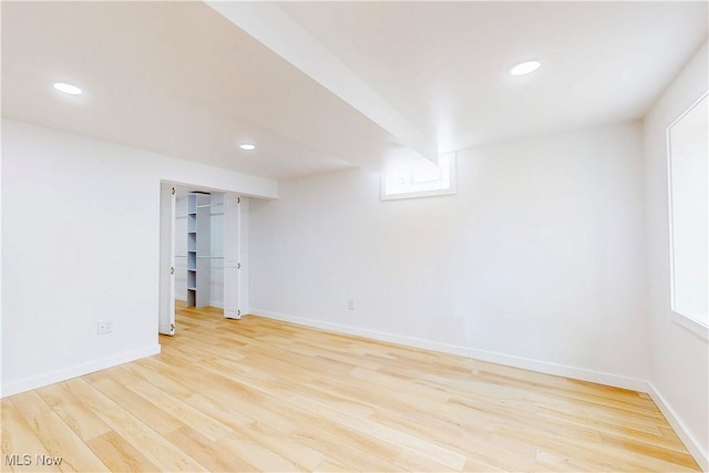 empty room with baseboards, light wood-style flooring, and recessed lighting