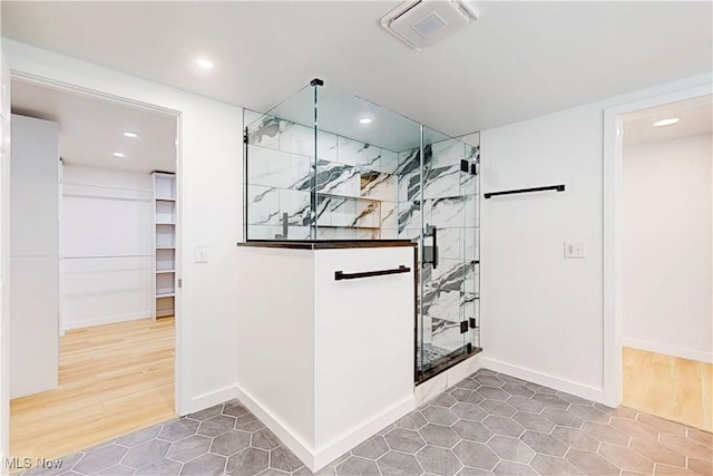 interior space featuring baseboards, visible vents, wood finished floors, and recessed lighting