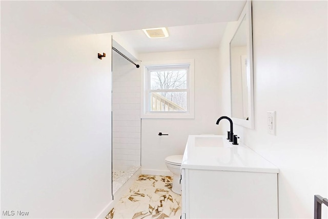 bathroom featuring toilet, vanity, baseboards, marble finish floor, and a tile shower