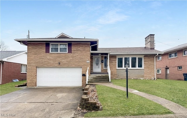 split level home featuring brick siding, a chimney, concrete driveway, a garage, and a front lawn